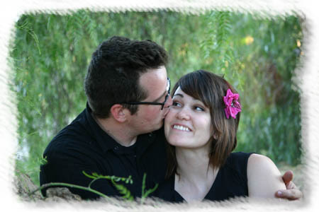 Engagement kiss under tree